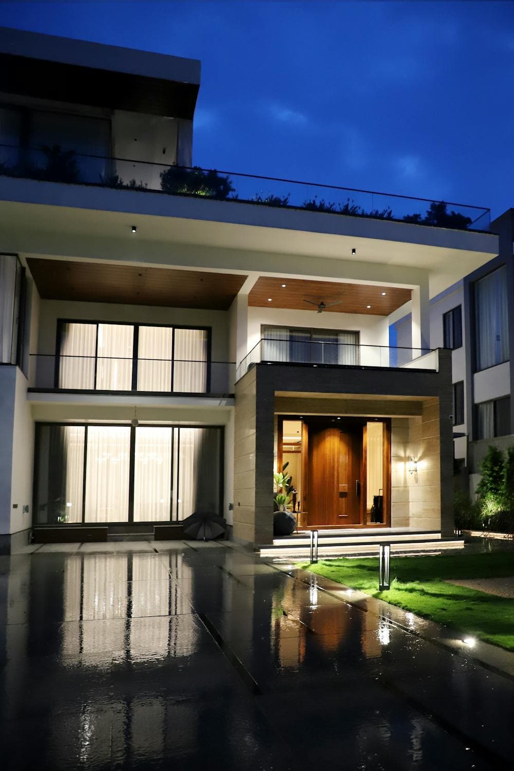 Luxury home with professional landscape lighting at night