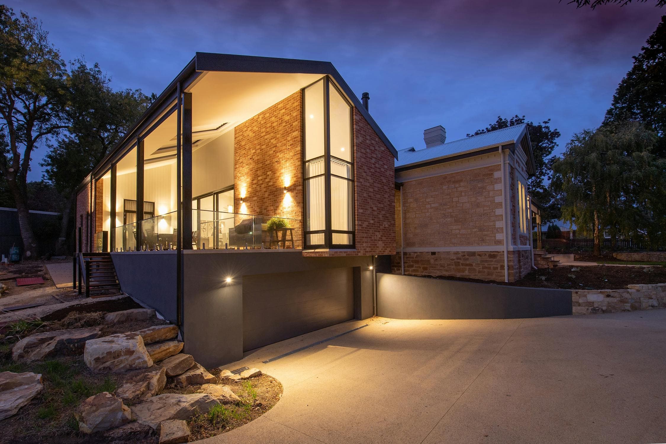 Modern home with professional outdoor lighting at dusk